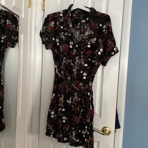 Black flower printed dress. Buttons all the way down front with a tie waist